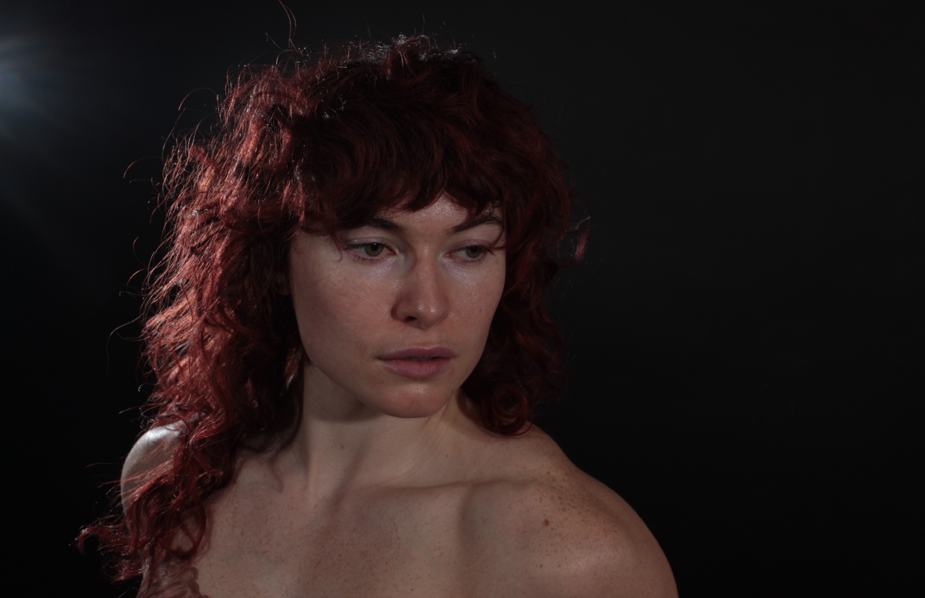 head shot of topless woman with strong backlight